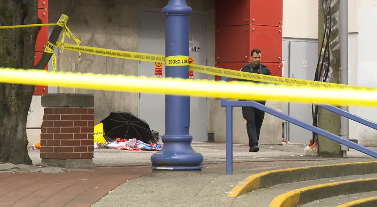 A Vancouver police officer examines evidence at the scene of a stabbing in Chinatown on Mon. July 24, 2023. The Sunday stabbing left a person with non-life-threatening injuries to their face.