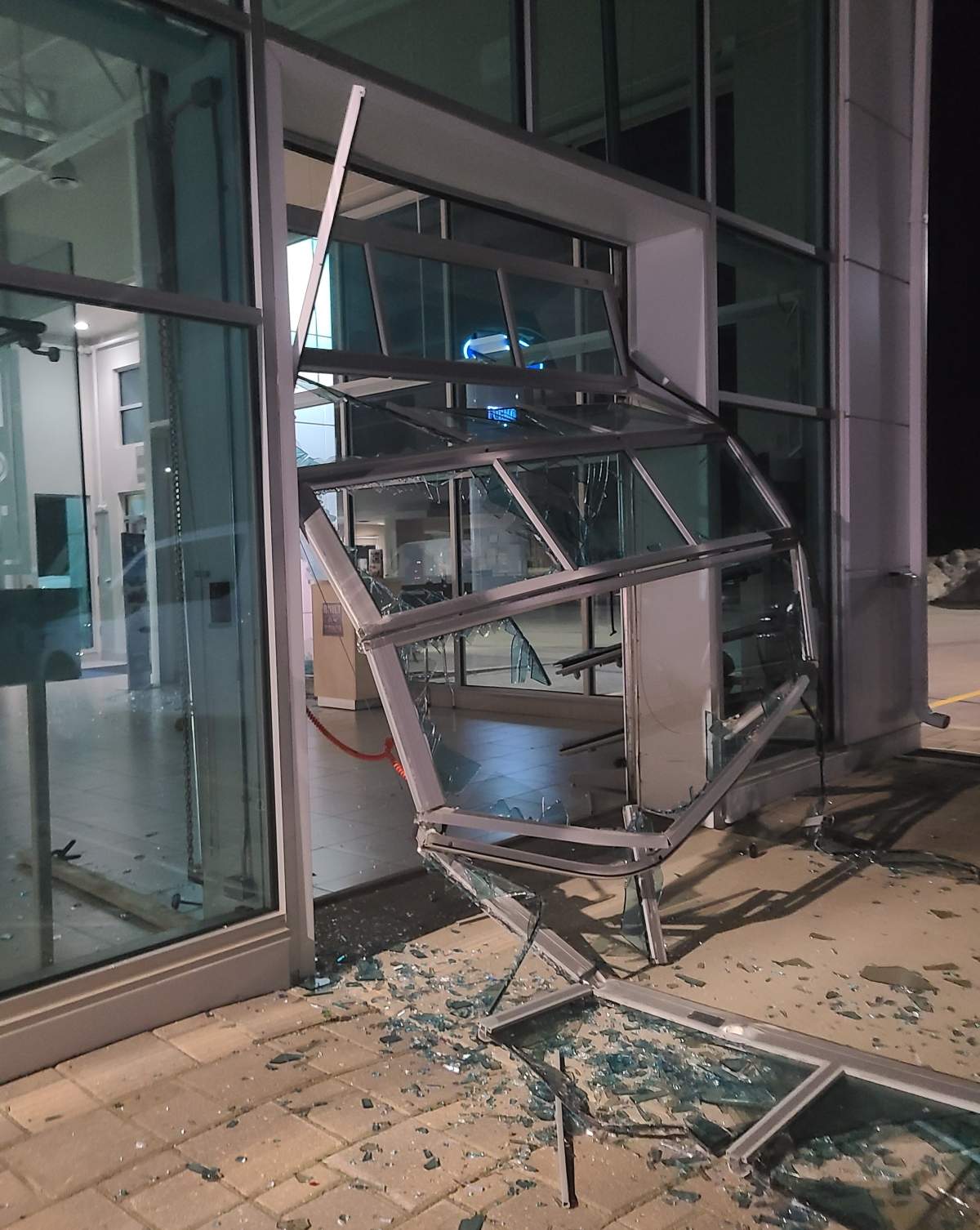 A photo of the damaged door to the business in Main Street.