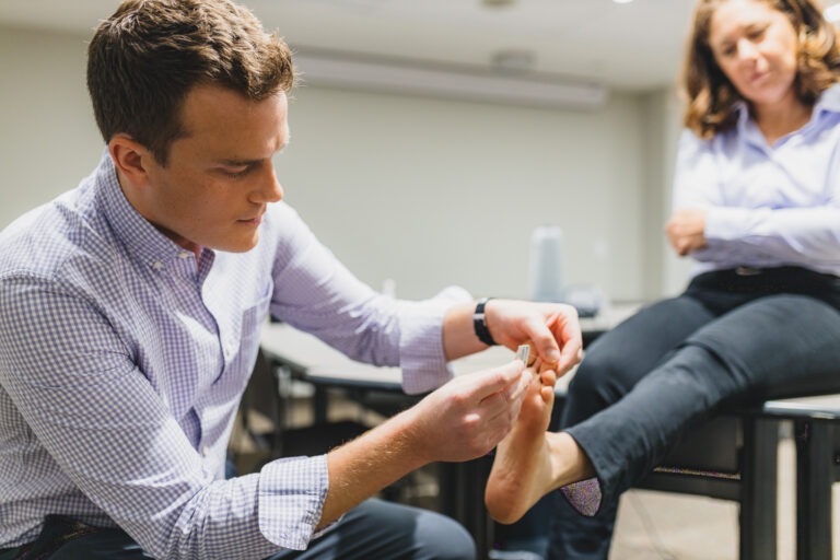 Dr. Brian McKenna demonstrates a foot check as part of a campaign seeking to decrease diabetes-related amputations.