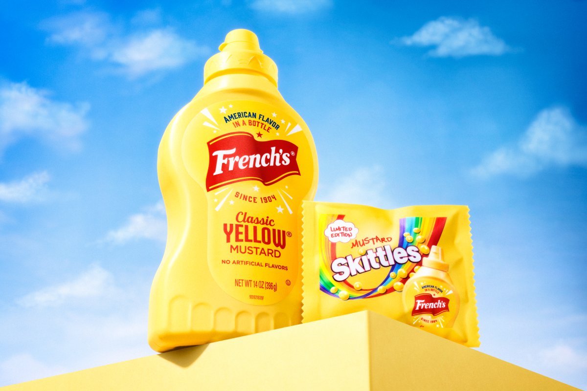 Mustard Skittles next to a French's yellow mustard container.