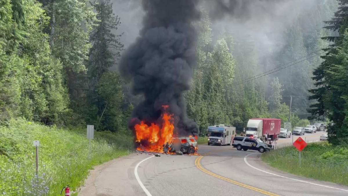 Flames engulf two vehicles on the Trans-Canada Highway following a fatal crash west of Revelstoke, B.C. on July 12, 2023.