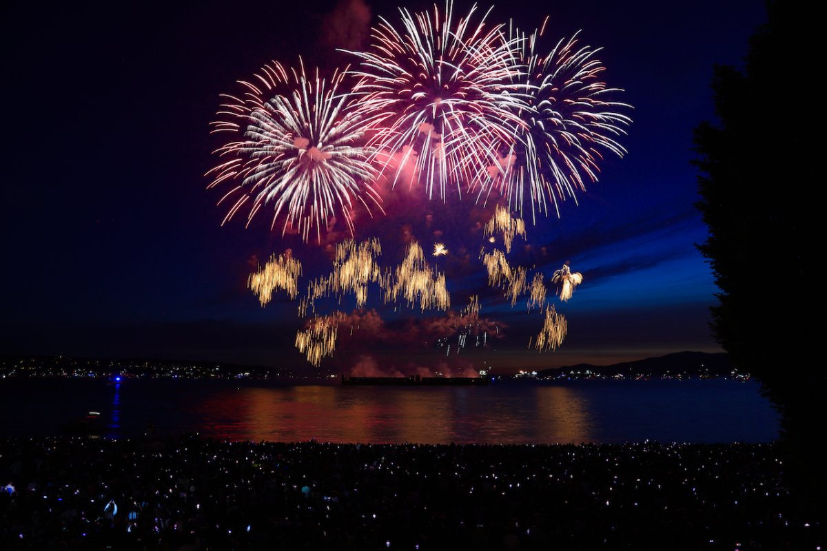 Spectators watch from the beach as fireworks explode over Vancouver's English Bay during team Mexico's performance at the Honda Celebration of Light fireworks festival on July 26, 2023.