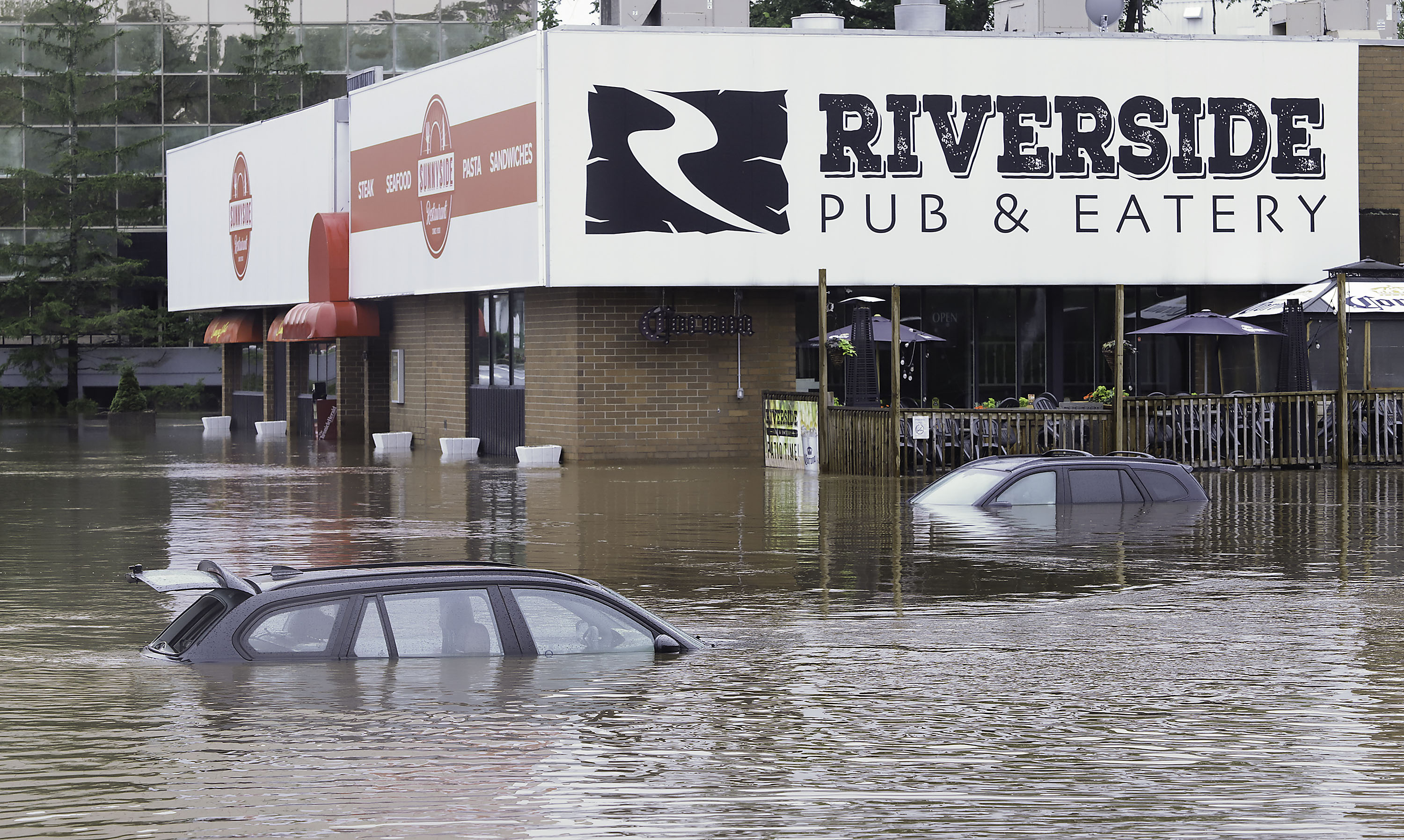 Parked vehicles were almost entirely submerged in water outside a restauraunt in Bedford on Saturday.