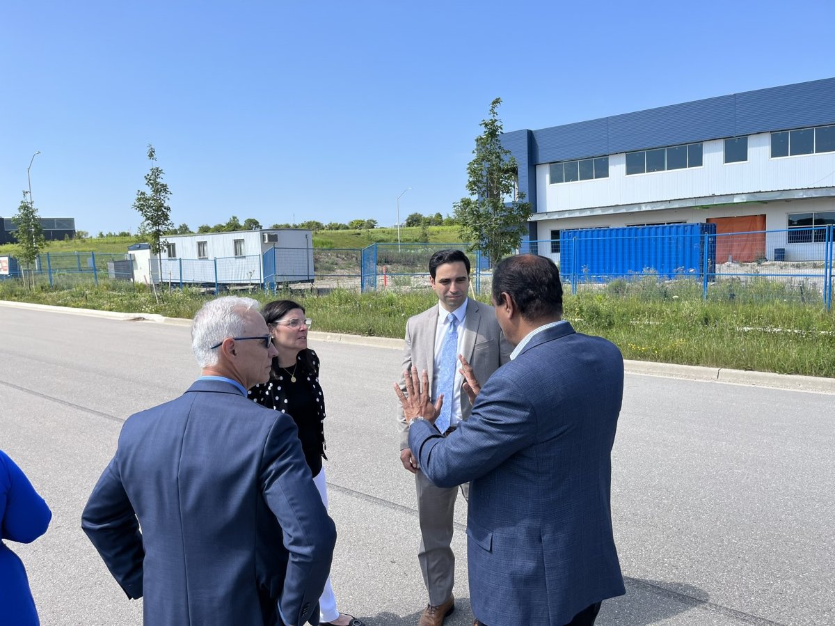 Minister Filomena Tassi, back left, and London North Centre MP Peter Fragiskatos, back right, at Anvo Laboratories in London on July 12, 2023.