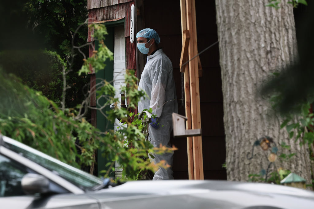 Law enforcement officials are seen as they investigate the home of a suspect arrested in the unsolved Gilgo Beach killings on July 14, 2023 in Massapequa Park, New York.