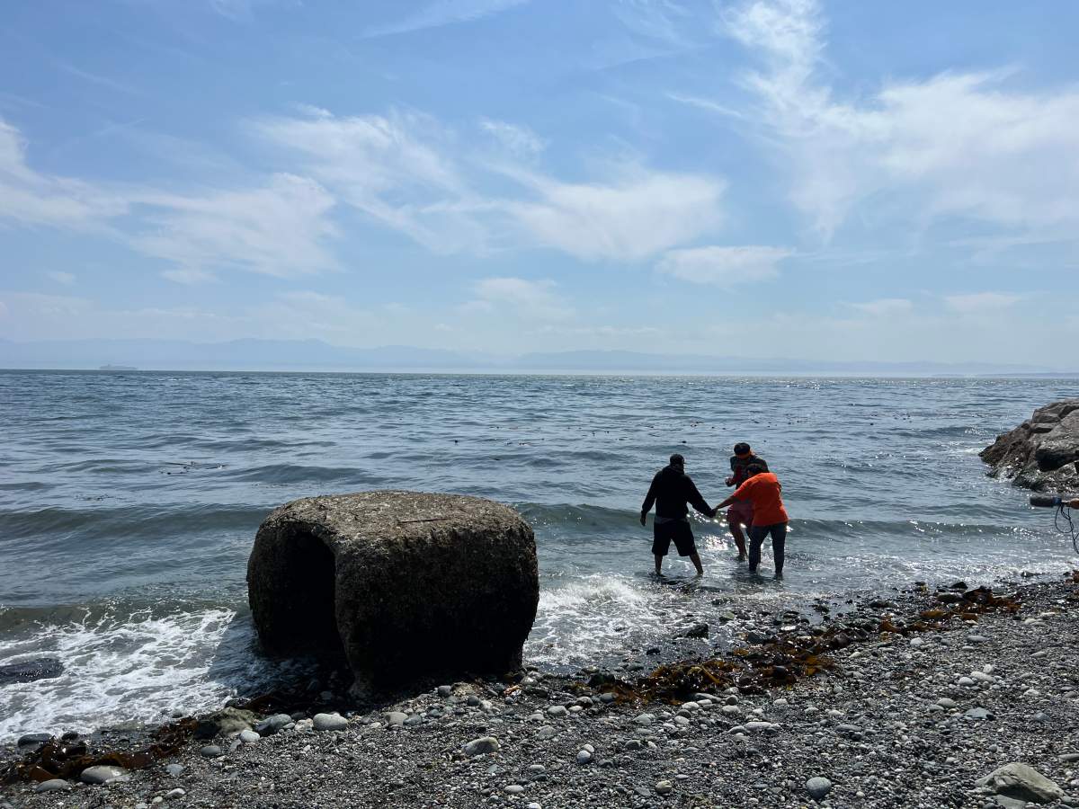 Ramona Big Head takes her first steps into the Pacific Ocean.