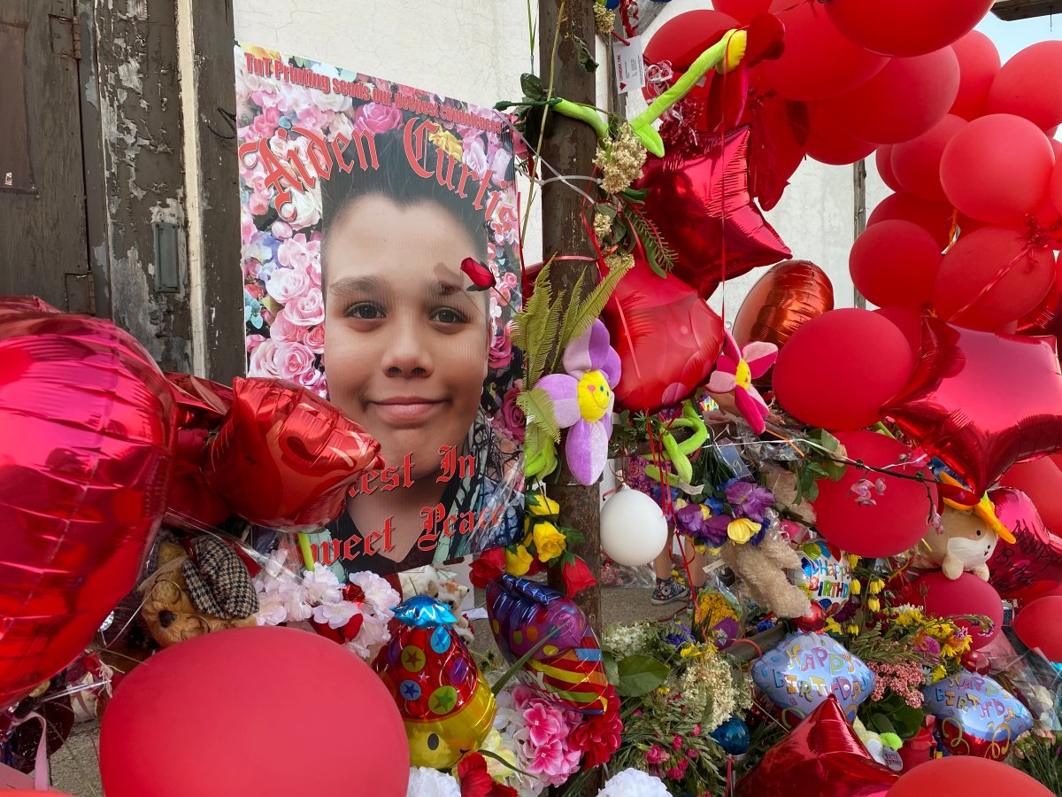 Hundreds of red balloons line houses across St. Thomas, Ont., on Monday at a vigil in memory of Aiden Curtis on what would have been his 12th birthday. Aiden was fatally struck by an allegedly impaired driver on July 4.