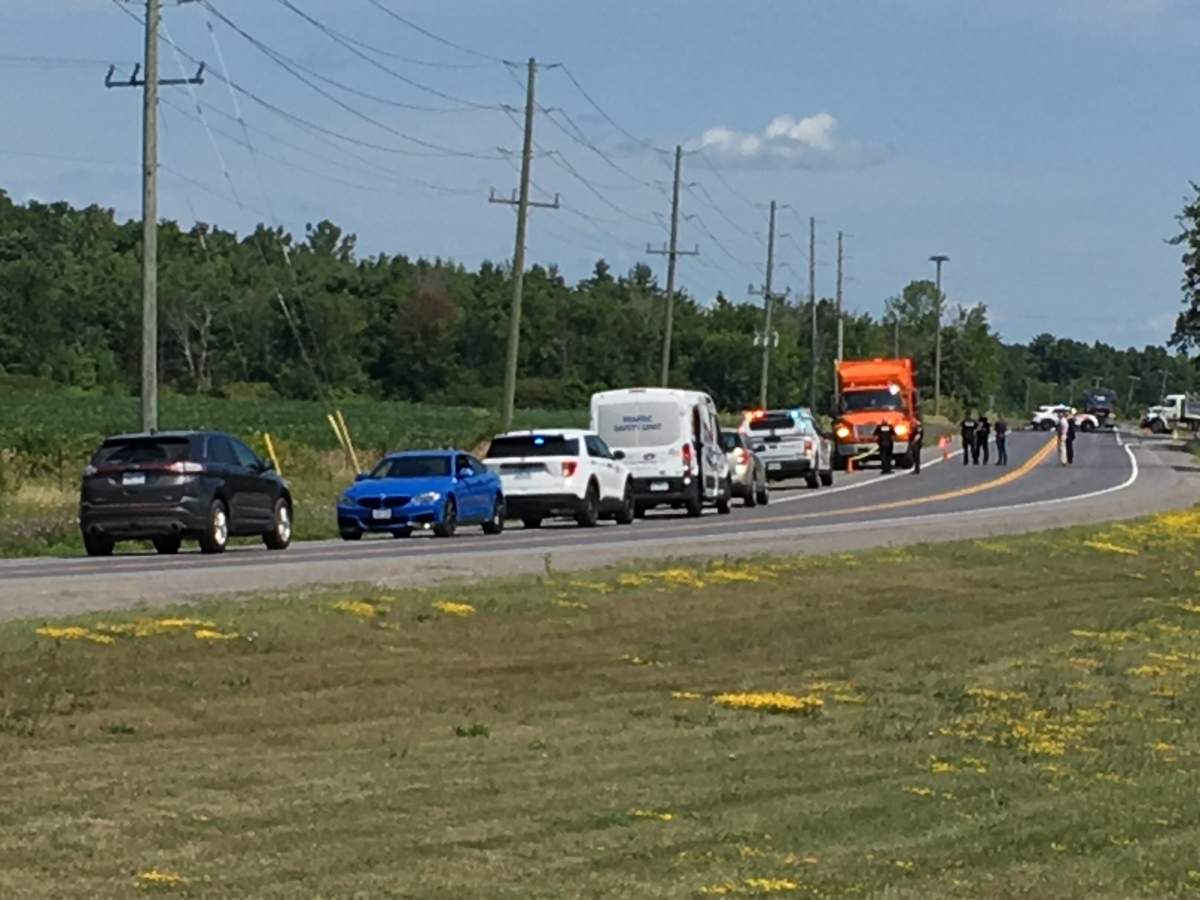 Kingston police say a City of Kingston employee spotted a body off of Battersea Road while driving by. 