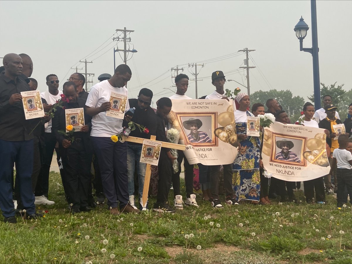 A crowd of people gathered at a memorial held for a man killed at Belvedere LRT Station last Sunday.