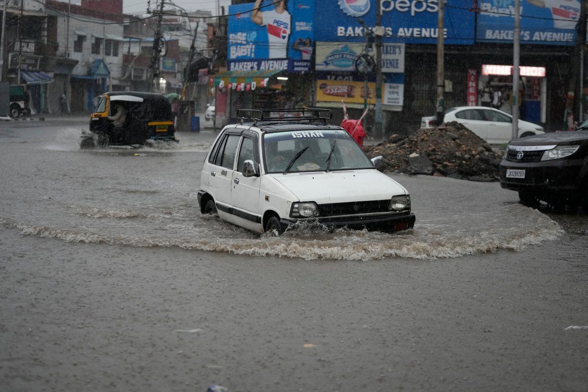 A car navigates its way through a flooded street in Jammu, India, Tuesday, July 4, 2023. The monsoon season in India lasts from June to September. (AP Photo/Channi Anand)