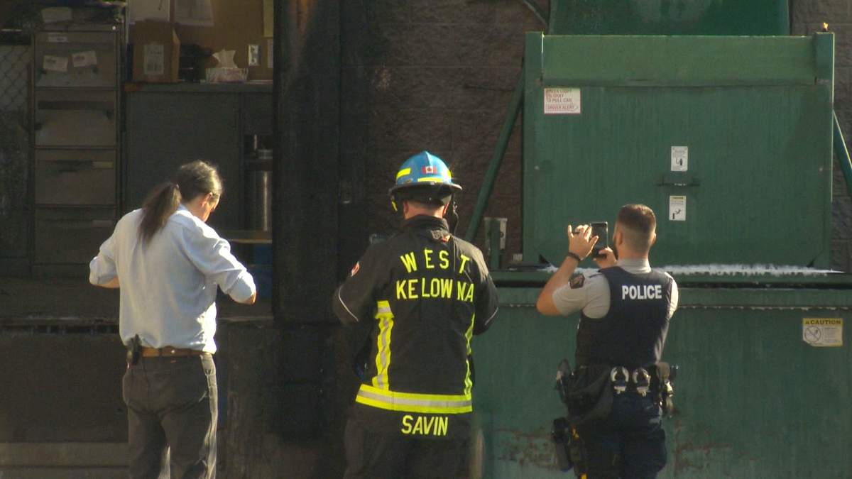 Police and fire officials taking photos of the extinguished fire on Friday evening.