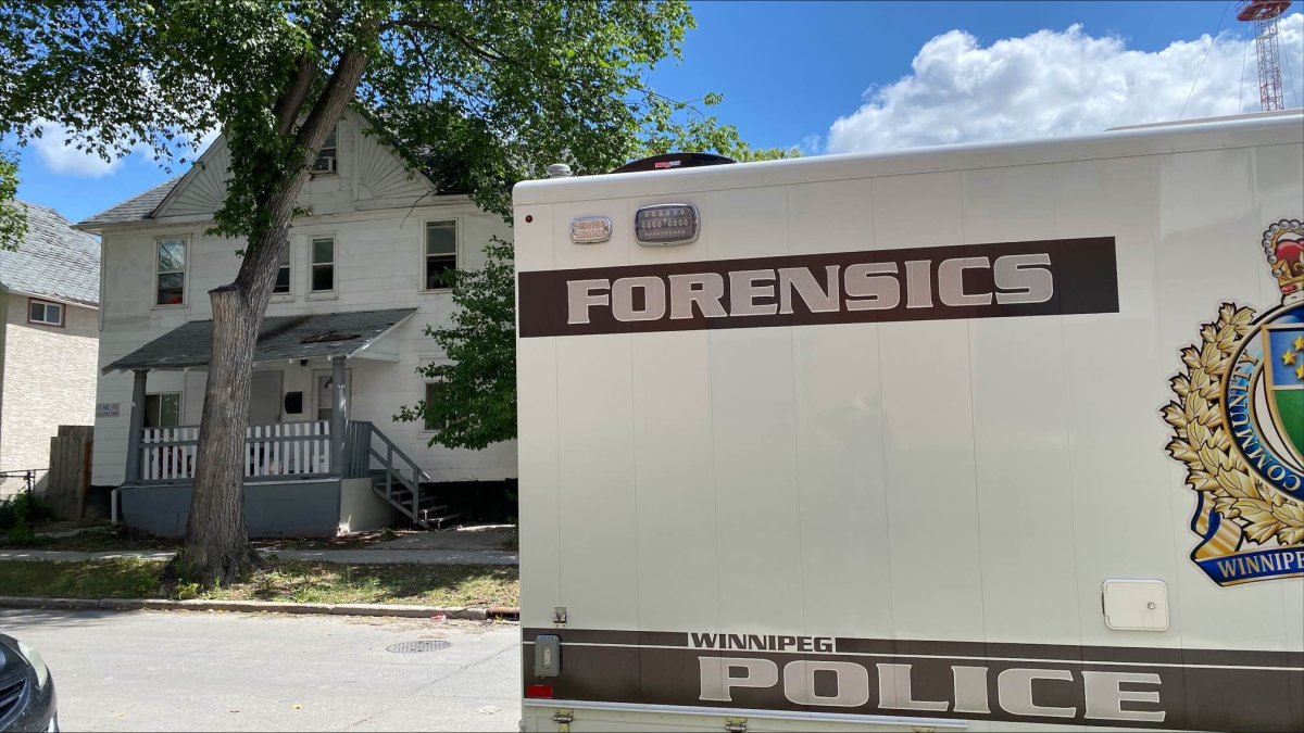 A Winnipeg police forensics vehicle on Langside Street in July. Police say they found a makeshift bomb in an apartment building while investigating the city's 26th slaying of the year.