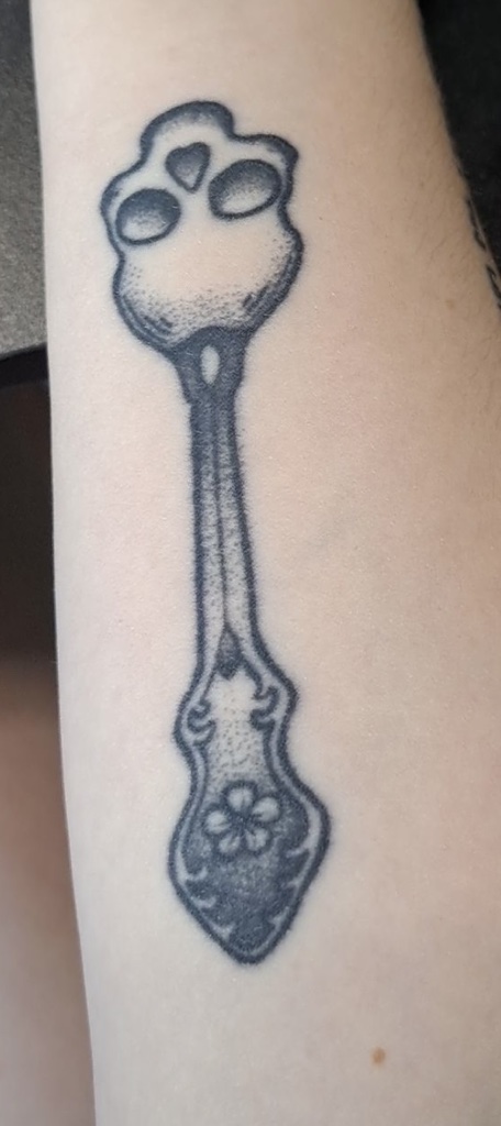 A tattoo of a spoon from a women with a chronic illness. She considers herself a spoonie.