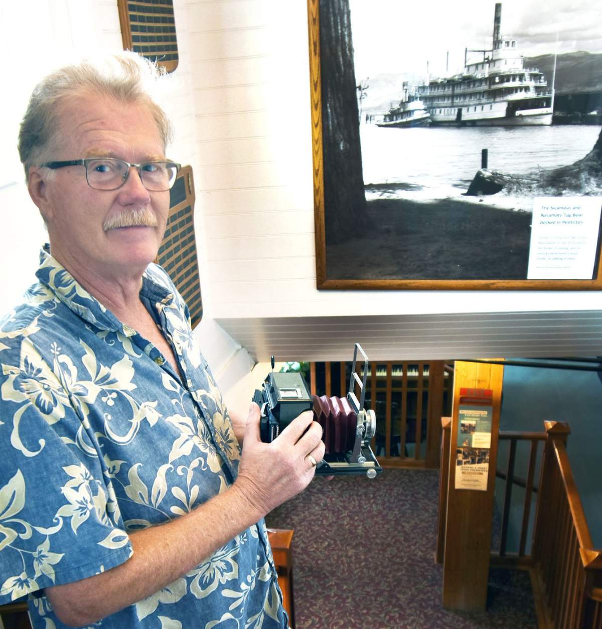 Chief archivist Brian Wilson of the Okanagan Archive Trust Society aboard the S.S. Sicamous with a camera once belonging to Eddie Aldredge, whose spirit is said to be on the ship.