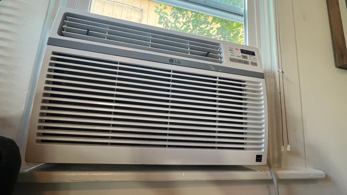 An air conditioning unit in the window of a home.