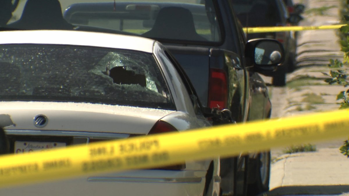 A sedan with a damaged rear window following a July 22 police response where a man, who had damaged a parked vehicle, was shot by an officer.