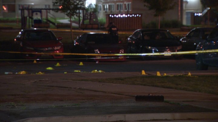 Evidence markers and police tape at the scene of a double shooting in Scarborough.