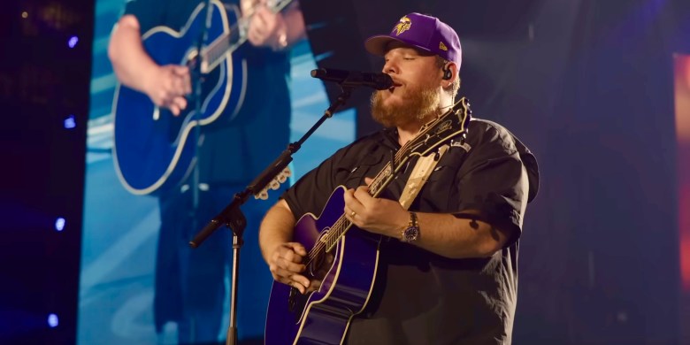 Watch as Luke Combs plays "Should've Been A Cowboy" to pay tribute to Toby Keith