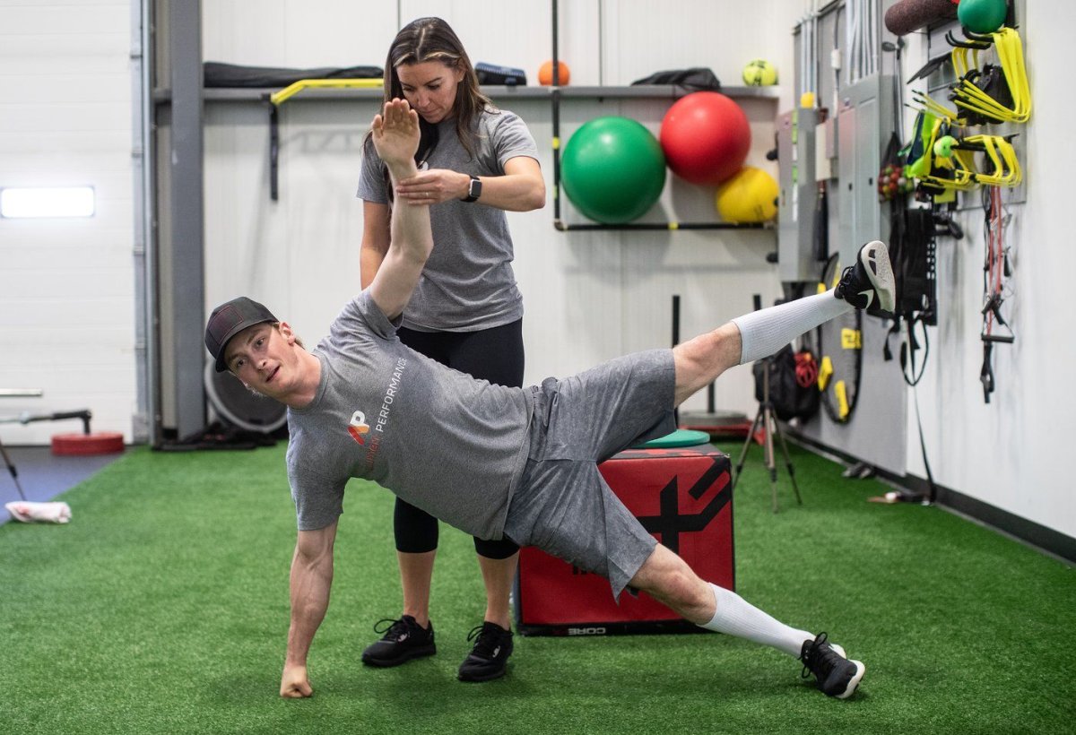 Athletic therapist LeeAnne Gullett works with bull rider Coy Robbins as he trains for the upcoming Calgary Stampede, at Acumen Performance in Edmonton, Monday, June 26, 2023. 