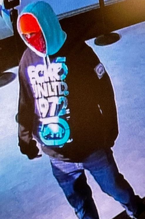 Police describe the suspect as a man wearing a light-colored hoodie with a black long-sleeve shirt over it with “ECKO UNLTD 1972” on it, an orange beanie, and a red mask.