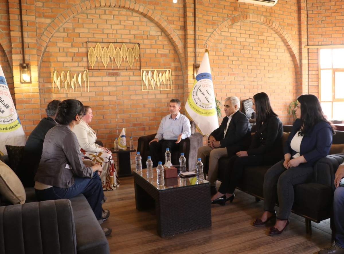 This photo, released by the administration that controls the Kurdish-majority northeast region of Syria, shows a visit by a Canadian delegation, left, before the handover of two female Canadian detainees in July 2023.
