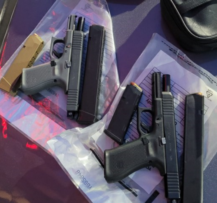 Two loaded Glock handguns were seized, police say.