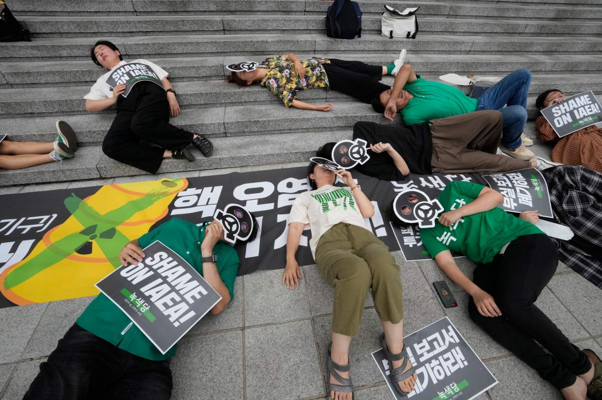 Environmental activists stage a die-in during a rally against Japanese government’s decision to release treated radioactive water from Fukushima nuclear power plant, in Seoul, South Korea, Saturday, July 8, 2023. (AP Photo/Ahn Young-joon)