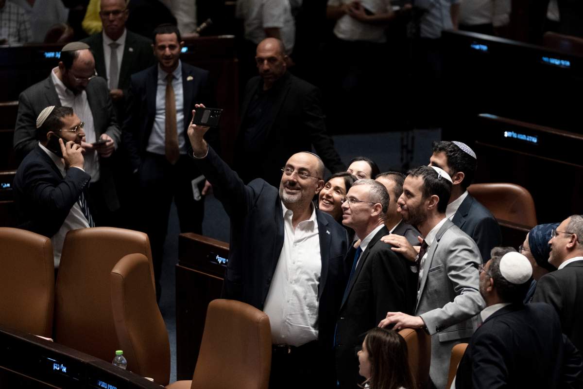 Israeli Lawmakers celebrate by taking a selfie with Minister of Justice Yariv Levin, center right in the foreground, after approving a key portion of Prime Minister Benjamin Netanyahu’s divisive plan to reshape the country’s justice system, on the floor of the Knesset, Israel’s parliament, in Jerusalem, Israel, Monday, July 24, 2023. (AP Photo/Maya Alleruzzo)
