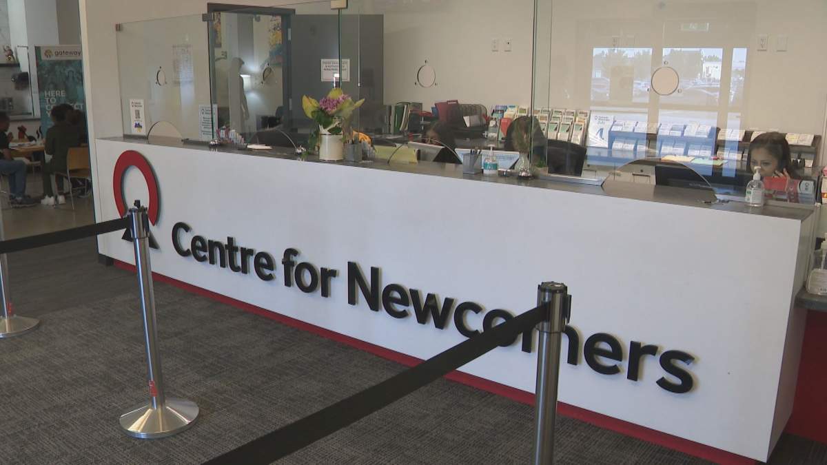 Employees at Calgary’s Centre for Newcomers reception desk on July 10, 2023.