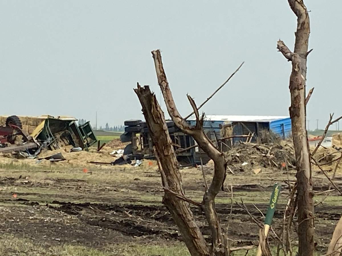 An overturned semi truck and trailer is pictured near Carstairs, Alta., on July 13, 2023.