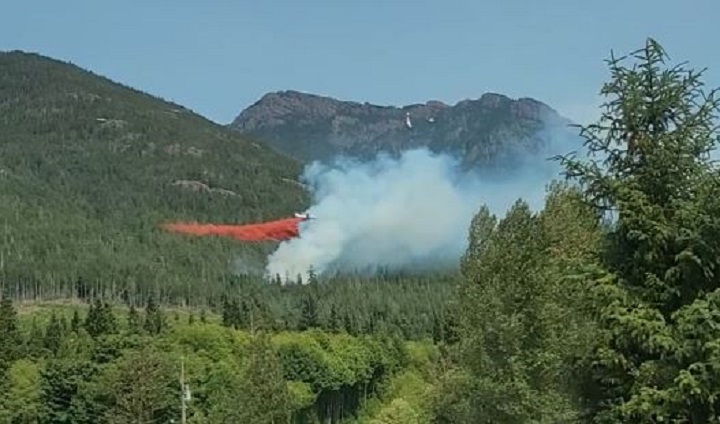 An air tanker drops retardant on a new wildfire near Sayward on Vancouver Island. 