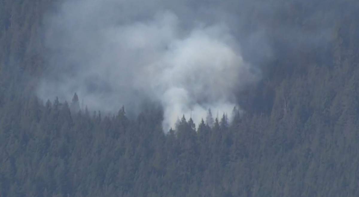 Smoke rises from a new wildfire on Mount Seymour on Wednesday, July 12, 2023.