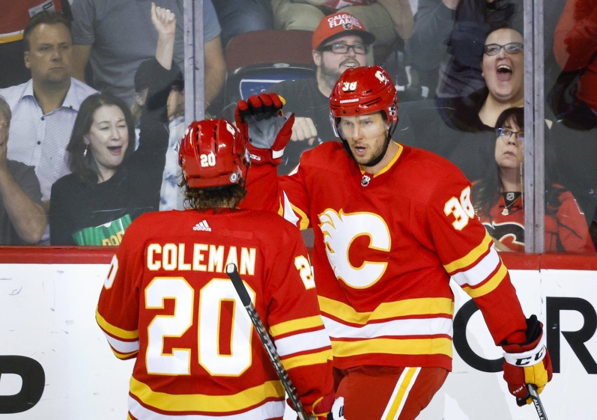 Calgary Flames centre Brett Sutter, right, celebrates his goal with teammate forward Blake Coleman during second period NHL pre-season hockey action against the Edmonton Oilers in Calgary, Wednesday, Sept. 28, 2022. The Flames have signed former coach Darryl Sutter's son Brett to a minor-league contract extension.