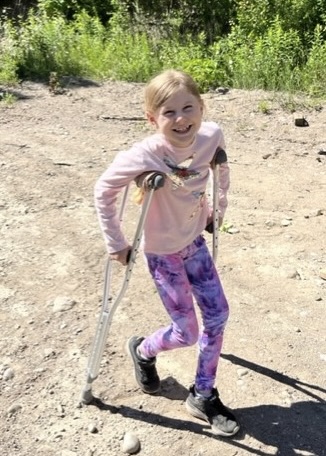 Grace Anstey, 9, on crutches after dislocating her knee.
