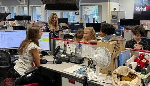 Carole Anne Devaney with our 2023 reporters for the day — Aaryan, Olivia, Cecily and Hudson —receiving their assignment in the Global Edmonton newsroom on Wednesday, August 23, 2023.