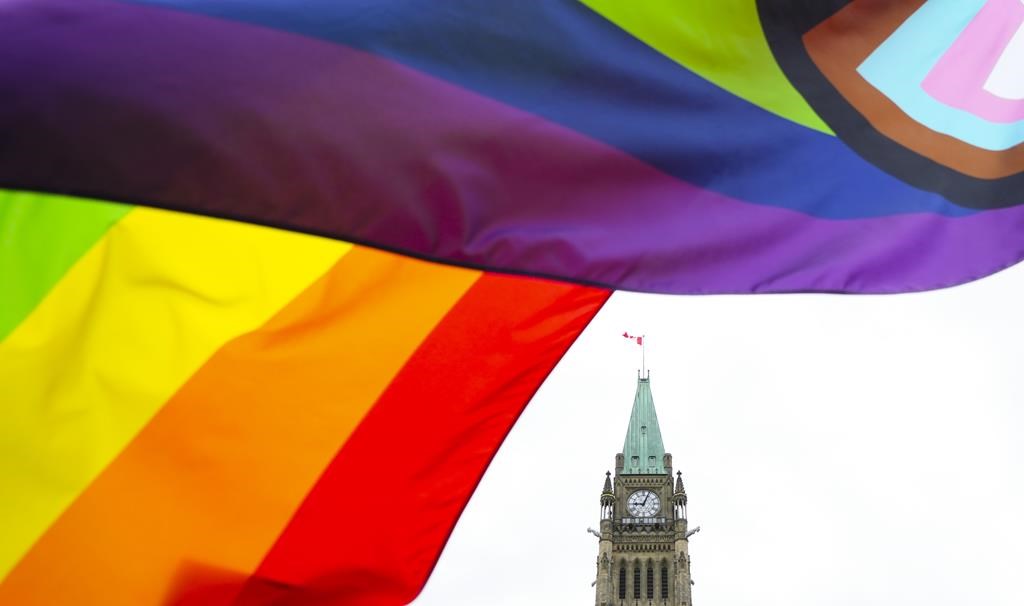 A Pride flag flies on Parliament Hill in Ottawa on Thursday, June 8, 2023, during a Pride event. A coalition of Ontario Pride organizations called on the province today to urgently work with them to develop a pro-active safety plan to beat back a rising tide of anti-LGBTQ hate.
