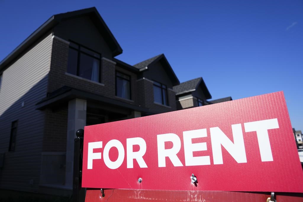 A for rent sign is displayed on a house in Ottawa on Friday, Oct. 14, 2022. 
