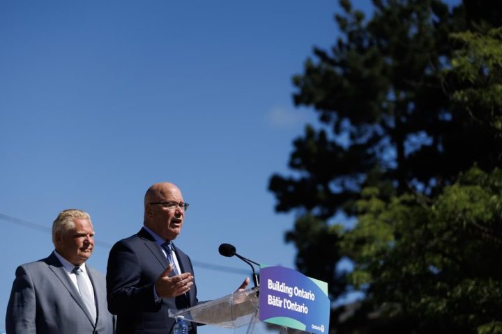 Ontario Premier Doug Ford listens as Clark speaks during a press conference in Mississauga, Ont., Friday, Aug. 11, 2023. 