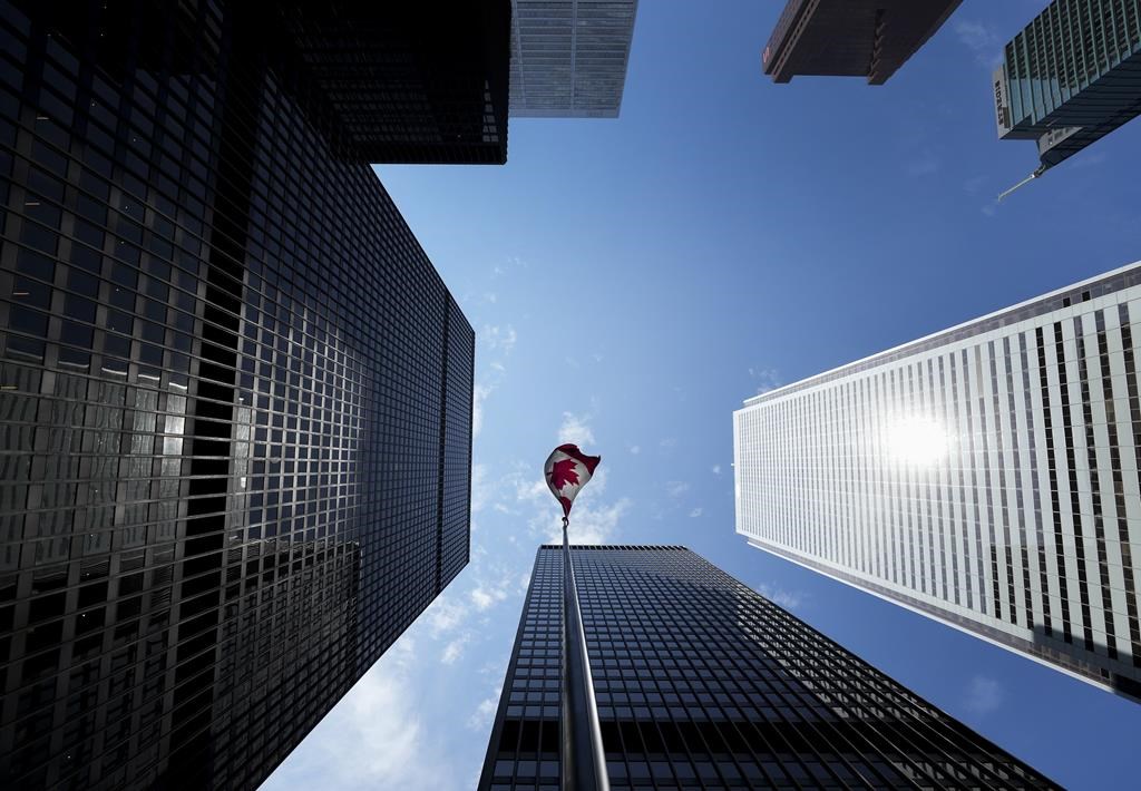 The Bay Street Financial District is shown with the Canadian flag in Toronto on Friday, August 5, 2022. THE CANADIAN PRESS/Nathan Denette.