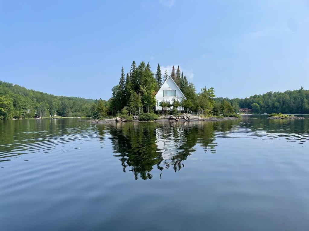 A Montreal-area company has come up with a novel — if extreme — way to boost employee happiness: buying them a private island. A building is seen on an island in an undated handout photo. The Labelle, Que., getaway includes a single, two-bedroom cabin with enough room for eight people, as well as a barbecue, pedal boat, dinghy and other water sport equipment. 