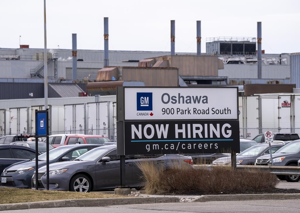 A sign announcing hiring is shown at the General Motors facility in Oshawa, Ontario on Monday April 4, 2022.