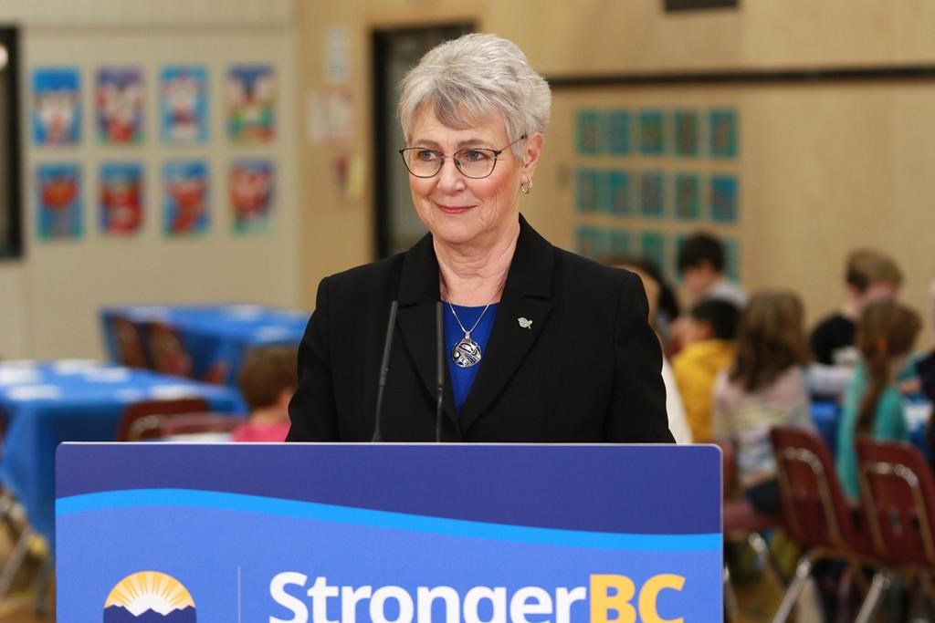 BC Finance Minister Katrine Conroy answers questions from reporters after serving up a hot lunch for students at Ruth King Elementary during a photo-op ahead of the budget while in Langford, B.C., on Feb. 27, 2023