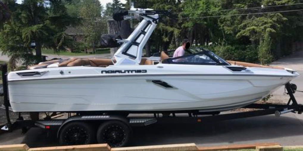 A white 2021 Centurion powerboat on a trailer Calgary police was stolen early on Aug. 1, 2023.