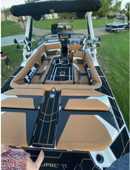 A white 2021 Centurion powerboat on a trailer Calgary police was stolen early on Aug. 1, 2023.