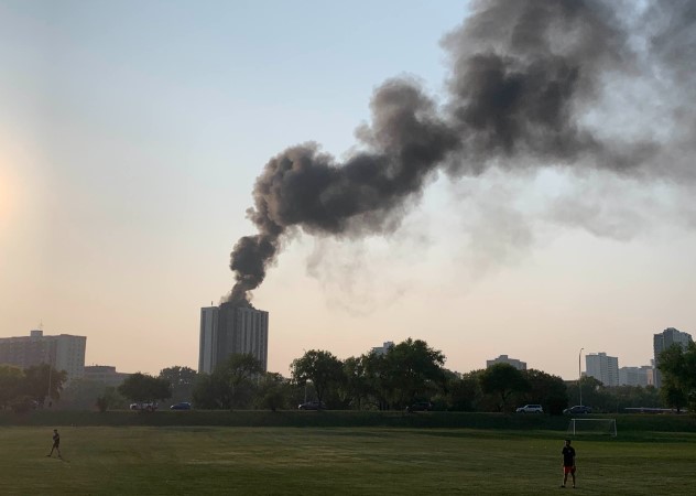 Smoke is seen billowing from an apartment building on Stradbrook Avenue Thursday evening. 