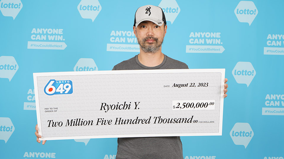 Ryoichi Yamada of North Vancouver with his lottery cheque worth $2.5 million.
