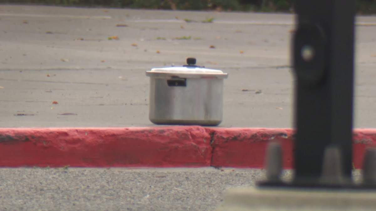 The suspicious package, later determined to be non-explosive, in the parking lot of Bishop O’Byrne High School Thursday morning.