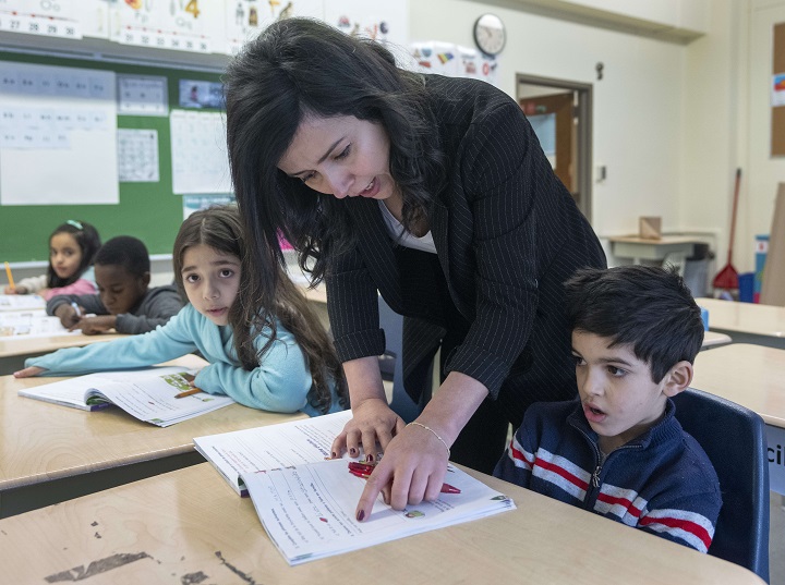 Teacher Nassima Sayah gives instructions during a French integration class for new arrivals, Wednesday, January 25, 2023 in Montreal.