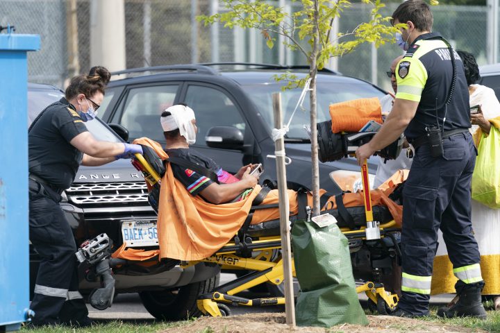 Toronto Paramedics treat a patient at the scene of a protest that turned violent in Earlscourt Park in Toronto, on Saturday, Aug. 5, 2023. Toronto police say one person was stabbed and eight others were injured during a protest in the city’s west end.