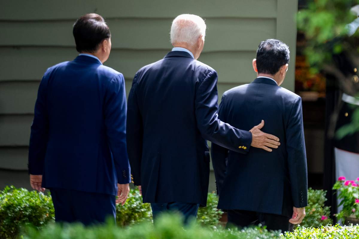 President Joe Biden greets South Korea’s President Yoon Suk Yeol, left, and Japan’s Prime Minister Fumio Kishida, right, Friday, Aug. 18, 2023, at Camp David, the presidential retreat, near Thurmont, Md. (AP Photo/Andrew Harnik)